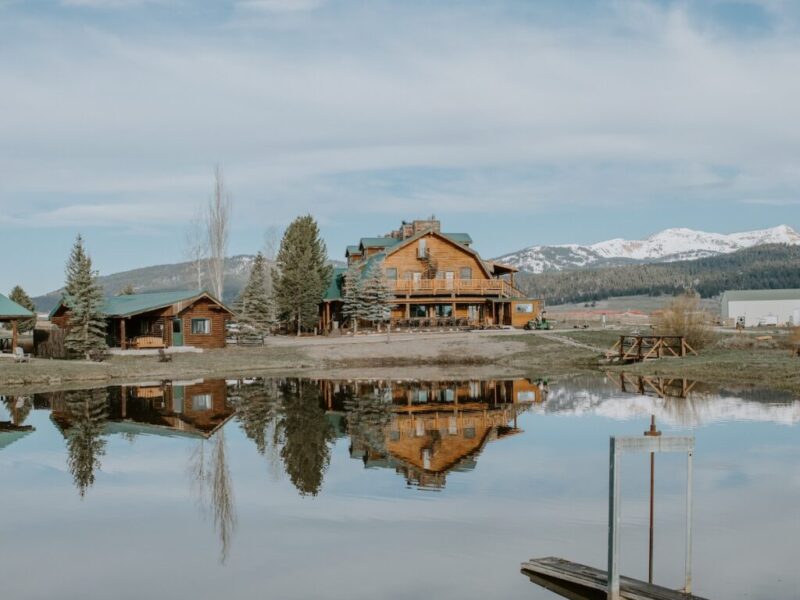 Bar and Ranch Main lodge back exterior with lake and mountains